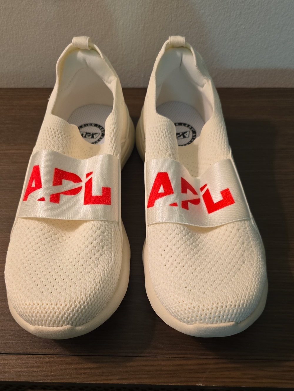NWOT APL Cream Slip-On Sneakers with Red Logo Band